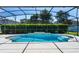 Gorgeous screened-in pool with water feature, lush hedges, and ample patio space for relaxing at 713 Duff Dr, Winter Garden, FL 34787