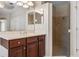 Bathroom vanity and walk-in shower featuring tile surround at 713 Duff Dr, Winter Garden, FL 34787