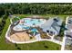 An aerial view of community pool, playground, and clubhouse with ample parking and surrounding green spaces at 7182 Painted Bunting Way, St Cloud, FL 34773