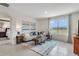 Cozy living room featuring a neutral sofa, stylish decor, and a large window with picturesque views at 7182 Painted Bunting Way, St Cloud, FL 34773