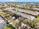 An aerial view of townhomes with mature trees providing shade, and neatly landscaped common areas surrounding the residences at 723 Marotta Loop, Ocoee, FL 34761