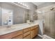 Well-lit bathroom featuring double sinks, a large mirror, and a glass-enclosed shower at 723 Marotta Loop, Ocoee, FL 34761