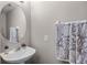 Well-lit half bathroom with a pedestal sink and decorative mirror at 723 Marotta Loop, Ocoee, FL 34761