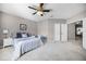 Spacious bedroom with a queen-sized bed, ceiling fan, and neutral color scheme at 723 Marotta Loop, Ocoee, FL 34761