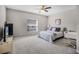 Bedroom with a neutral color scheme, a ceiling fan, and a window view of the trees at 723 Marotta Loop, Ocoee, FL 34761