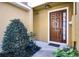 Inviting front entryway featuring a decorative wreath on the dark brown front door at 723 Marotta Loop, Ocoee, FL 34761