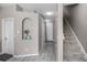 Hallway view with grey flooring and a stairway to the right, providing a neutral backdrop at 723 Marotta Loop, Ocoee, FL 34761