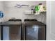 Laundry room with Samsung front-loading washer and dryer and wire shelving at 723 Marotta Loop, Ocoee, FL 34761