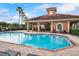 Community pool featuring a covered seating area and well-maintained landscaping at 723 Marotta Loop, Ocoee, FL 34761