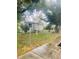 View of fenced backyard featuring grass and a side view of the house at 7531 Marietta St, Orlando, FL 32807