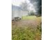 View of the home's backyard showing the house's rear entrance and a large lawn at 7531 Marietta St, Orlando, FL 32807