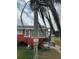 A red stucco home featuring decorative anchor detail, surrounded by green grass and a palm tree at 833 E 24Th Ave # 106, New Smyrna Beach, FL 32169