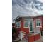 Red stucco house featuring a glass door and white trim detail with anchor accents at 833 E 24Th Ave # 106, New Smyrna Beach, FL 32169