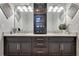 Bathroom featuring dual sinks with granite countertops and dark wood cabinetry at 8718 Shimmering Pine Pl, Sanford, FL 32771