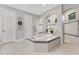 Relaxing bathroom featuring a soaking tub, a separate shower, and neutral tile at 8718 Shimmering Pine Pl, Sanford, FL 32771