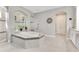 Elegant bathroom featuring a tiled shower, soaking tub with tile accents, and natural light at 8718 Shimmering Pine Pl, Sanford, FL 32771