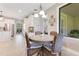 Charming breakfast nook featuring a round table with wicker chairs, adjacent to the bright and modern kitchen at 8718 Shimmering Pine Pl, Sanford, FL 32771