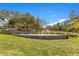 Welcoming community entrance featuring stone landscaping and a serene water fountain at 8718 Shimmering Pine Pl, Sanford, FL 32771