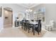 Airy dining room with a large window, stylish furnishings, and a decorative chandelier for sophisticated dining at 8718 Shimmering Pine Pl, Sanford, FL 32771