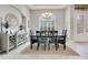 Inviting dining room features a dark wood table, light-colored walls, and a decorative light fixture above at 8718 Shimmering Pine Pl, Sanford, FL 32771