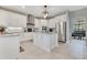 Spacious kitchen featuring white cabinets, stainless steel appliances, and ample counter space for cooking and entertaining at 8718 Shimmering Pine Pl, Sanford, FL 32771