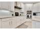 Bright kitchen showcasing white cabinets, granite countertops, stainless steel appliances, and tile backsplash at 8718 Shimmering Pine Pl, Sanford, FL 32771