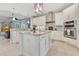 Well-lit kitchen with white cabinetry, granite countertops, and stainless steel appliances for a modern culinary space at 8718 Shimmering Pine Pl, Sanford, FL 32771