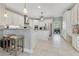 Bright, modern kitchen with white cabinetry, stainless steel appliances, and a breakfast bar with stool seating at 8718 Shimmering Pine Pl, Sanford, FL 32771