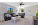 Comfortable living room featuring leather furniture, neutral carpeting, and ample natural light at 8718 Shimmering Pine Pl, Sanford, FL 32771