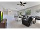 Cozy living room with comfortable seating, a ceiling fan, and a view of the outdoors at 8718 Shimmering Pine Pl, Sanford, FL 32771