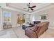 Inviting living room with a tray ceiling, comfortable leather seating, and a large window for natural light at 8718 Shimmering Pine Pl, Sanford, FL 32771