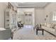 Spacious living room featuring elegant furnishings and neutral colors, bathed in natural light from large windows at 8718 Shimmering Pine Pl, Sanford, FL 32771