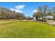 Street view of the manicured lawns and gardens along the neighborhood entrance at 8718 Shimmering Pine Pl, Sanford, FL 32771