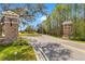 Picturesque view of the street with stone pillars marking the entrance to the neighborhood at 8718 Shimmering Pine Pl, Sanford, FL 32771