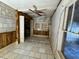 Versatile living space with tiled floors, wood paneling, and natural light at 8801 Hackney Prairie Rd, Orlando, FL 32818