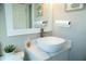 Stylish bathroom featuring a vessel sink, modern faucet, and a quartz countertop on a white vanity at 919 N Hastings St, Orlando, FL 32808