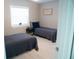 This bedroom features a bright window, twin beds, and a minimalist decor style at 919 N Hastings St, Orlando, FL 32808