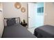 Bedroom with two twin beds, neutral decor, and an open door leading to the hallway at 919 N Hastings St, Orlando, FL 32808