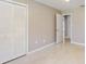 Bedroom features a closet with bi-fold louvered doors and neutral wall paint at 926 Ensenada Dr, Orlando, FL 32825