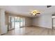 Inviting living room featuring sliding glass doors that open to a backyard and light wood floors at 926 Ensenada Dr, Orlando, FL 32825