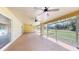 Spacious screened-in porch with tiled floors and ceiling fans, perfect for outdoor relaxation at 926 Ensenada Dr, Orlando, FL 32825