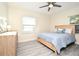 Bedroom with a ceiling fan, wood-look floors, and a dresser for ample storage at 938 S Bumby Ave, Orlando, FL 32806