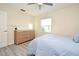 Bright bedroom with a window, wood-look floors, and a dresser for storage at 938 S Bumby Ave, Orlando, FL 32806