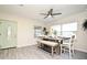 Light dining room with wooden table, neutral bench seating, and modern ceiling fan at 938 S Bumby Ave, Orlando, FL 32806