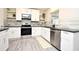 Bright kitchen featuring white cabinets, stainless steel appliances, and gray backsplash at 938 S Bumby Ave, Orlando, FL 32806