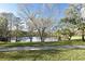 Picturesque lake view surrounded by mature trees and lush green grass at 938 S Bumby Ave, Orlando, FL 32806