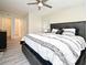 Spacious main bedroom with a king-sized bed, stylish bedding, and an open doorway to the en-suite bathroom at 938 S Bumby Ave, Orlando, FL 32806