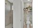 Stylish half bathroom featuring a walk-in shower and modern shelving at 17019 Seville Orange Rd, Winter Garden, FL 34787