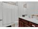 Bright bathroom featuring a shower/tub combo with white shower curtain and dark wood vanity with white countertop at 17019 Seville Orange Rd, Winter Garden, FL 34787