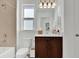 Bright bathroom with a granite countertop, under-sink cabinet, and decorative lighting at 17019 Seville Orange Rd, Winter Garden, FL 34787